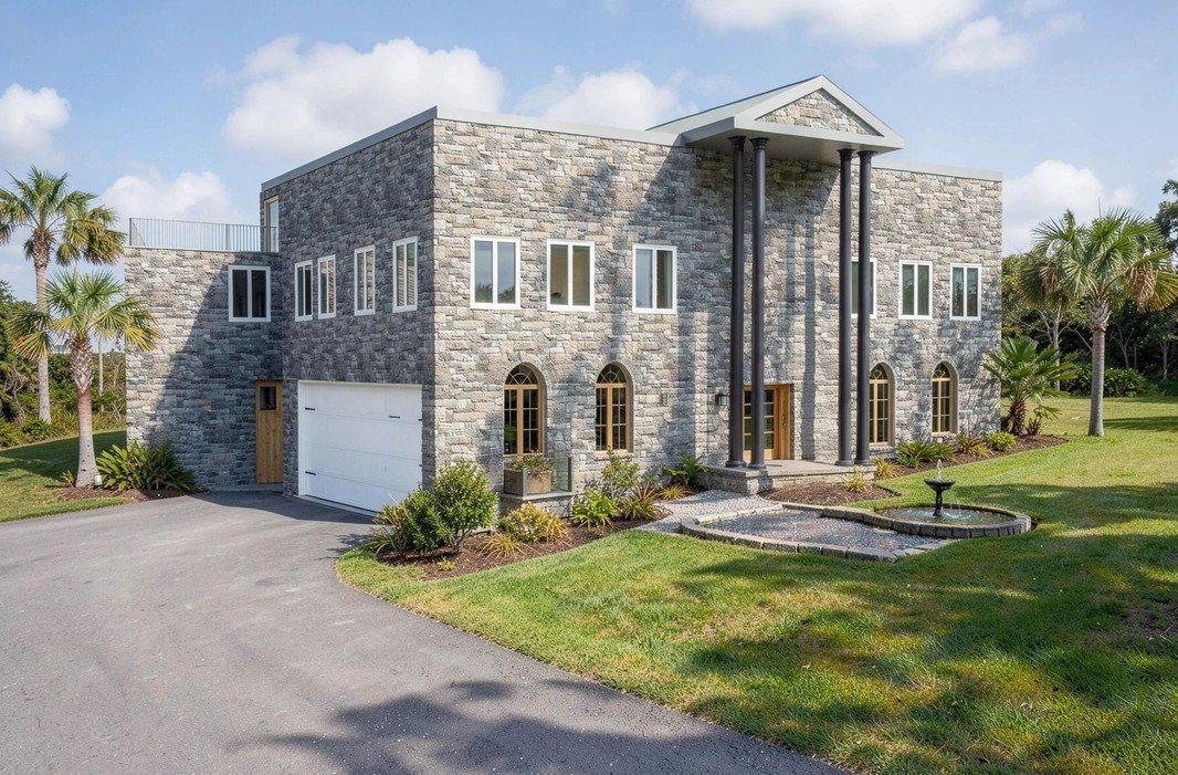 A neighbouring house on the road — stone walls, low overhangs