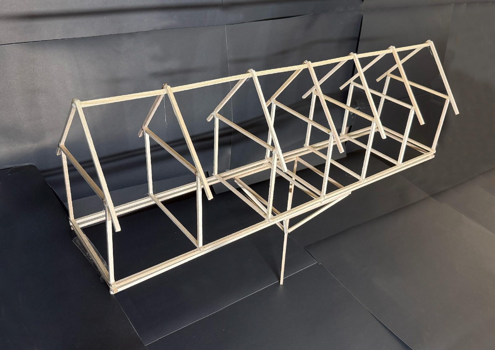 The frame, whole — eight bays under one roof, no pier in the water