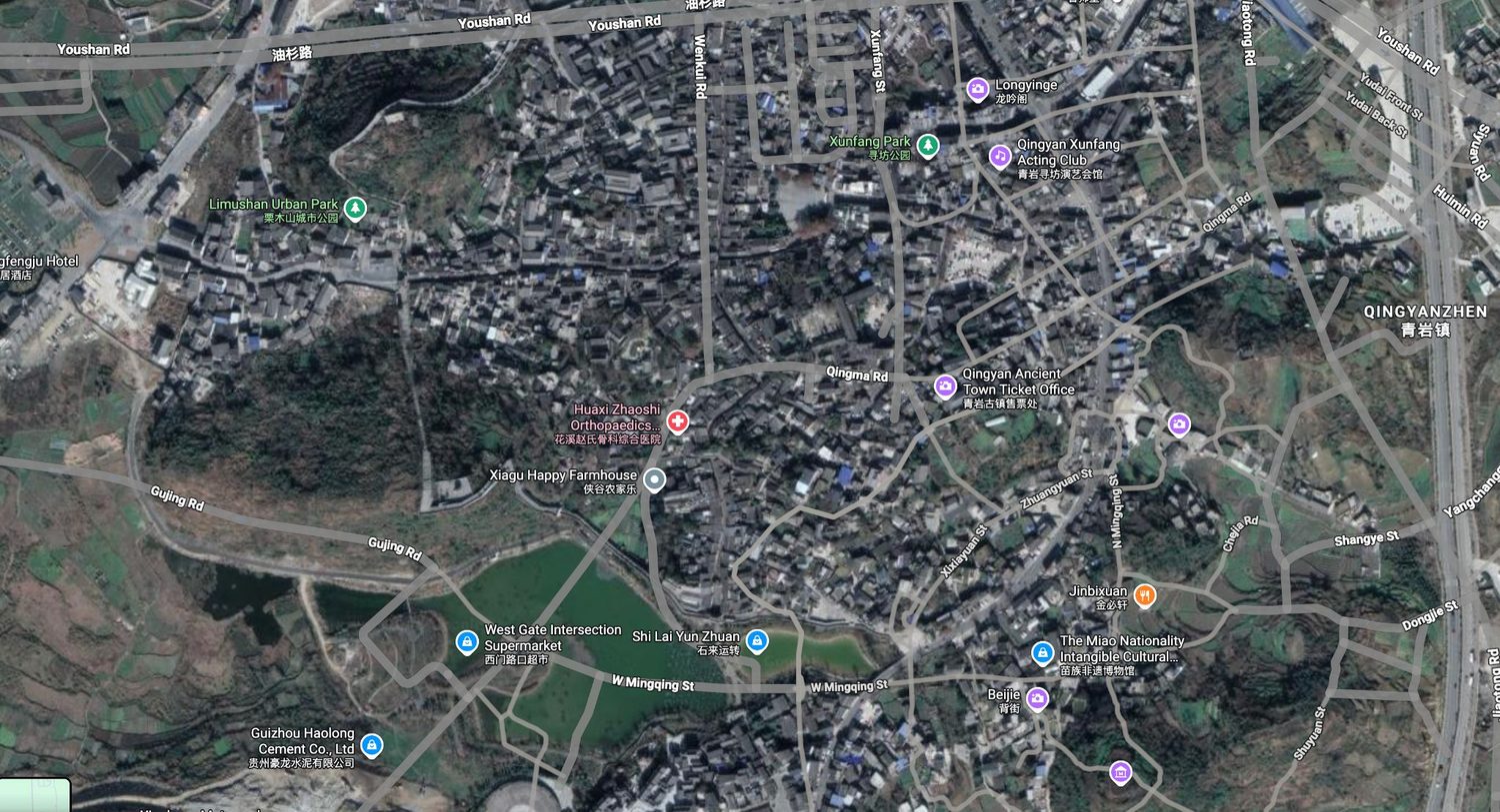Site aerial — entrance, old shops, temple and the bridge location